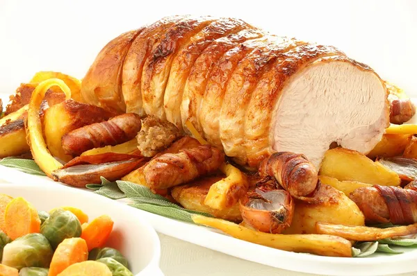 Roast rolled turkey breast with roast vegetables