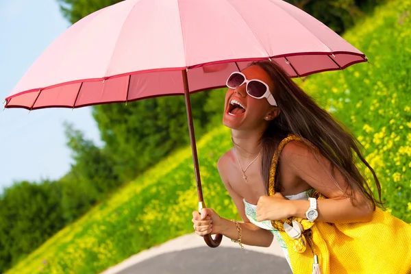 Pretty young woman with pink umbrella