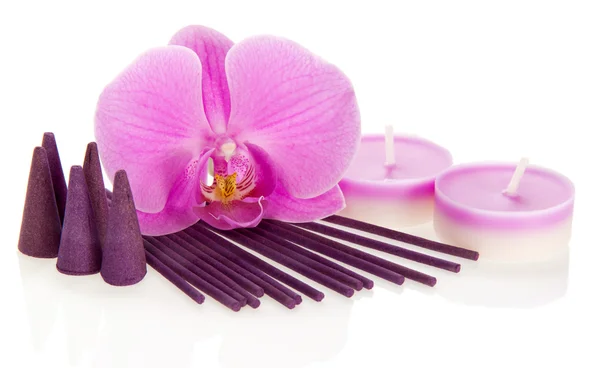 Orchid flower, aromatic sticks and cones, the candles isolated on white