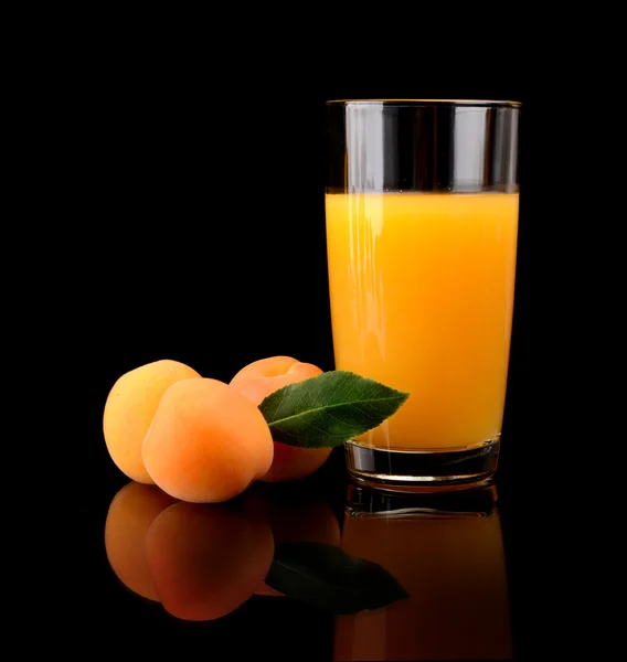 Close-up shot sliced orange apricot with juice and leaf