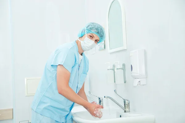 Surgeon washing hands before operation