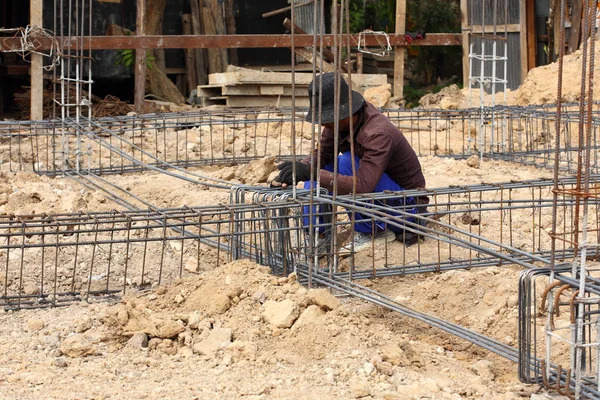 Worker prepare steel rod for construction job