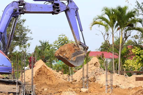 Backhoe tractor works on a construction site