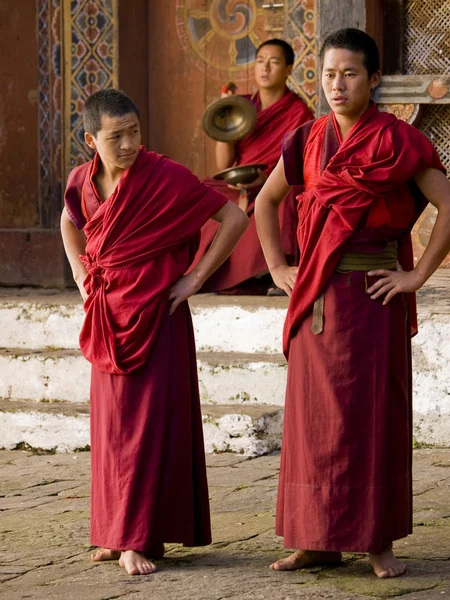 Anxious looking monks waiting for their rehearsal