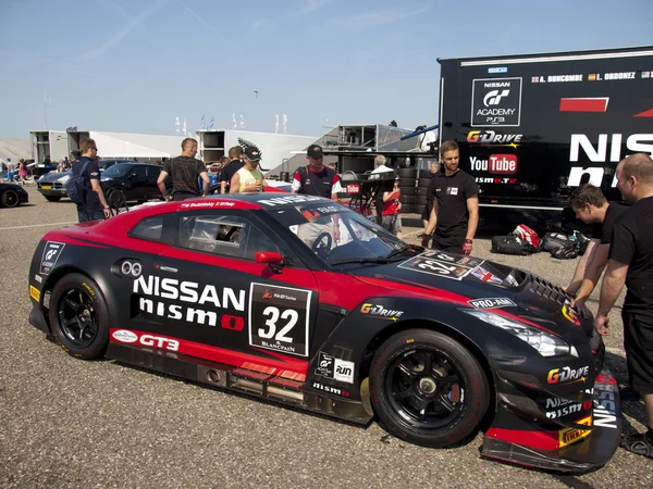 A Nissan GT-R NISMO GT3 is stalled behind the pitlane