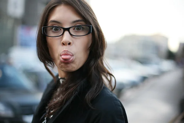 Young businesswoman woman sticking out her tongue
