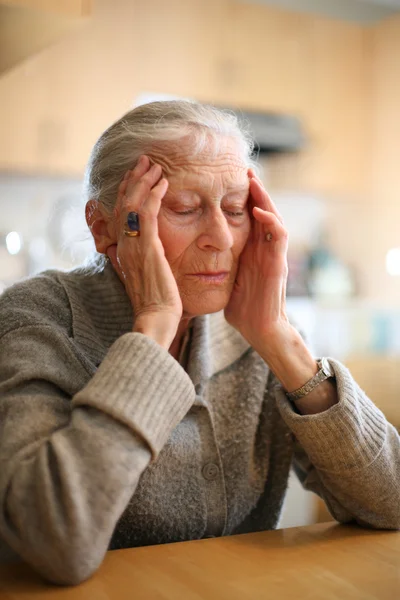 Senior woman relaxing to end headache