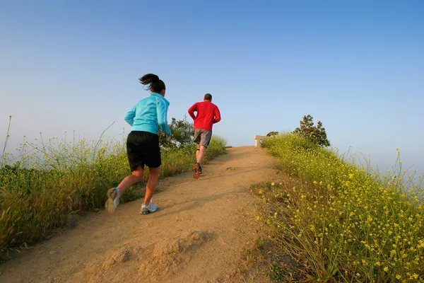 Two people running at Runyon Canyon Park