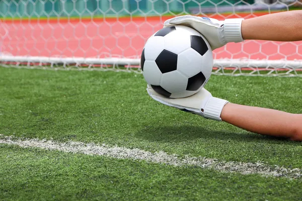Goalkeeper's hands catching soccer ball