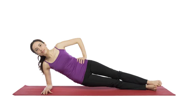 Young woman doing a variation of side plank pose