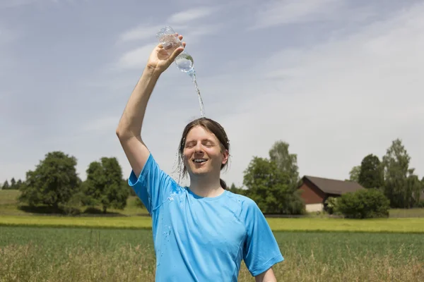 Young jogger refreshing after sports