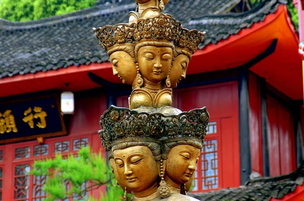 Emeishan, China: Column with Multiple Buddha Faces at Wan Nian Temple