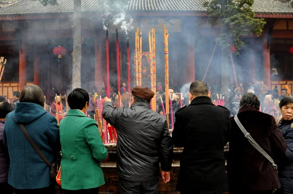 Pengzhou, China: People Lighting Incense Sticks at Chinese Temple