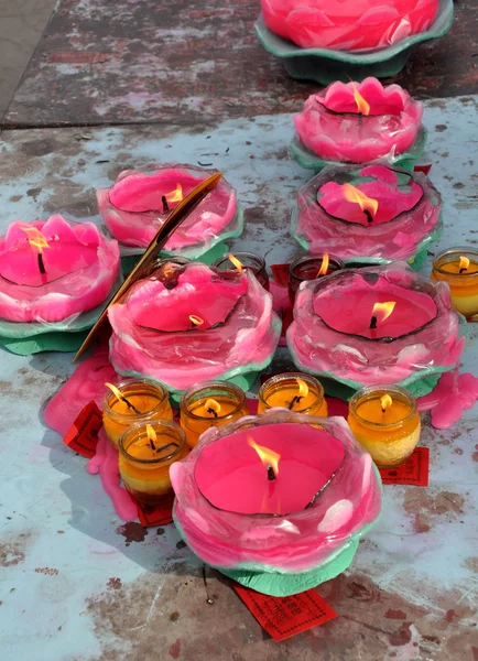 Pengzhou, China: Pink and Yellow Votive Candles at Chinese Temple