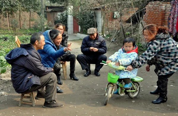 Pengzhou, China: Mother Teaching Child to Ride Bicycle