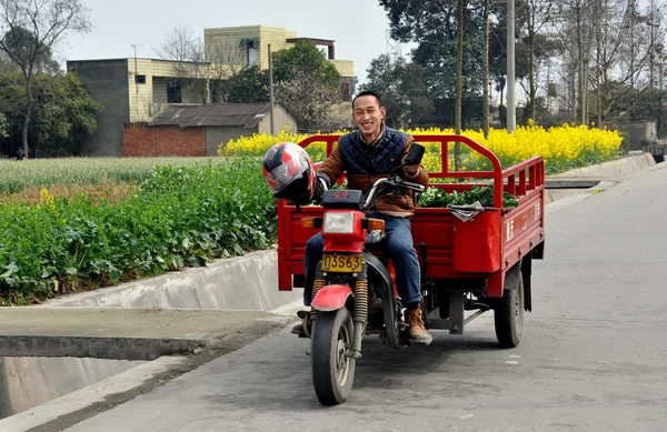 Pengzhou, China: Farmer Driving Motorcycle Cart on Country Road