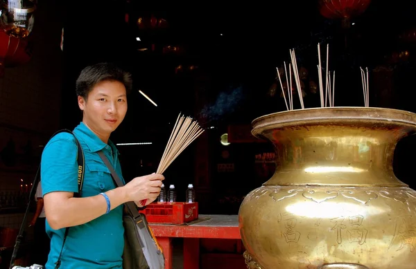 Georgetown, Malaysia: Young Man with Incense Sticks