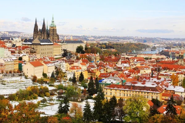 Autumn snowy Prague City with gothic Castle