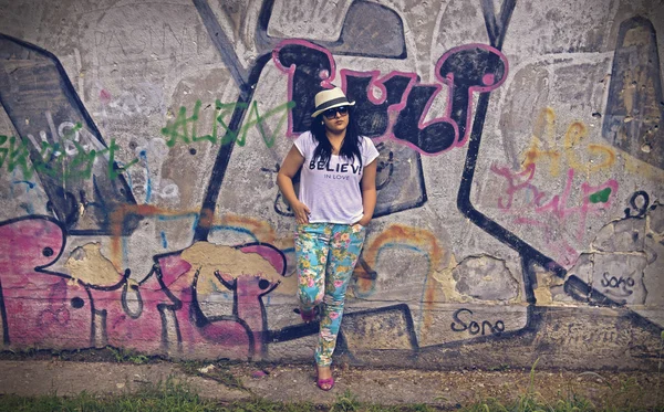 Fashion Girl with Wall Covered with Graffiti