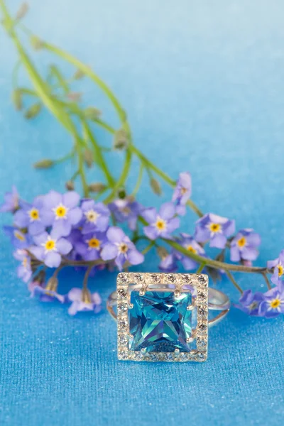 Elegant jewelry and blue flowers