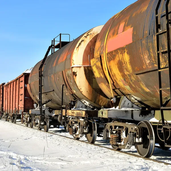 Grunge cargo train on the move in winter