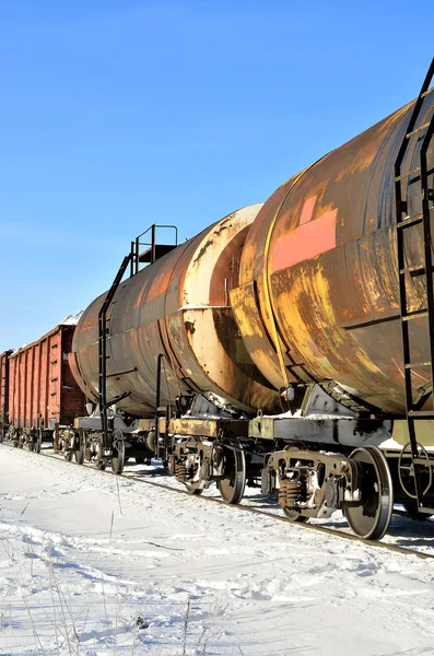 Grunge cargo train on the move in winter