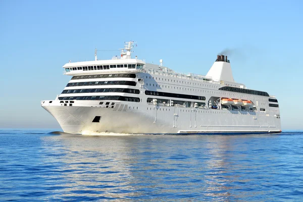 White passenger ferry ship sailing in still water