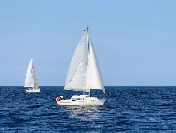 Two white sail yachts sailing. Riga, Latvia