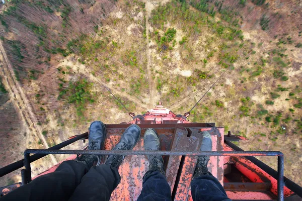 Urban explorers standing at the top of abandoned tower