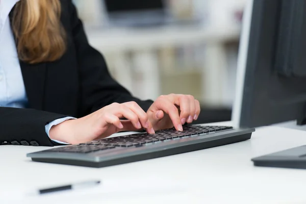 Female hands on a computer keyboard