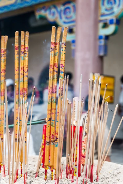 Joss sticks burn at an altar in chinese temple