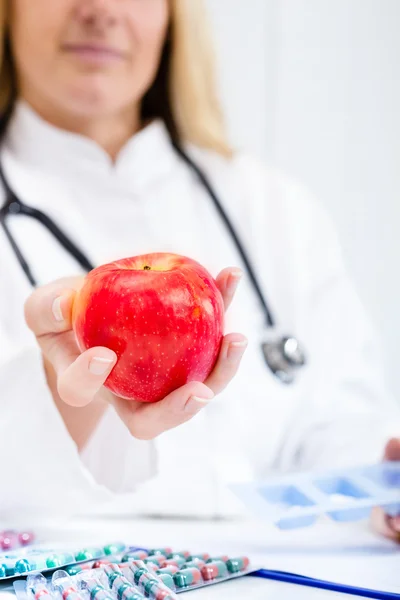 Healthy apple vs food supplements, concept