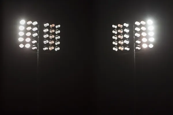 Stadium lights against dark night sky background — Stock Photo #33418799