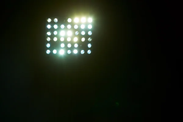 Stadium lights against dark night sky backgroundon