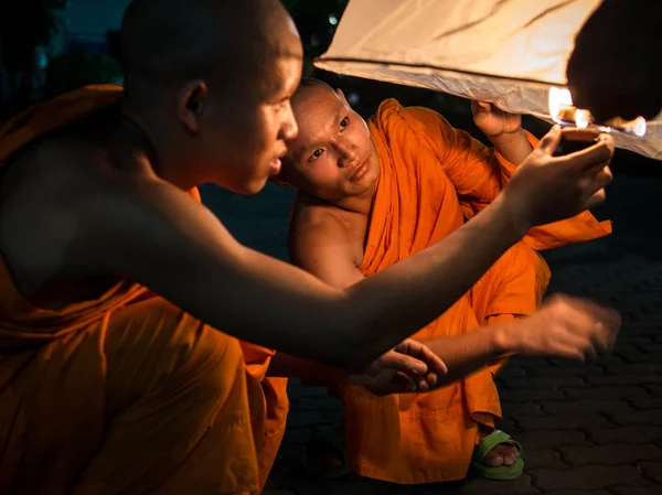 Buddhist Monks Lighting Up Hot Air Balloon at Loi Krathong 2013 Festival