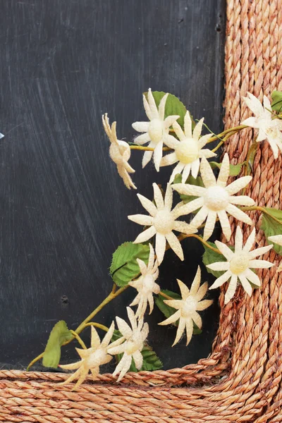Beautiful gerbera artificial flowers on a wooden frame.