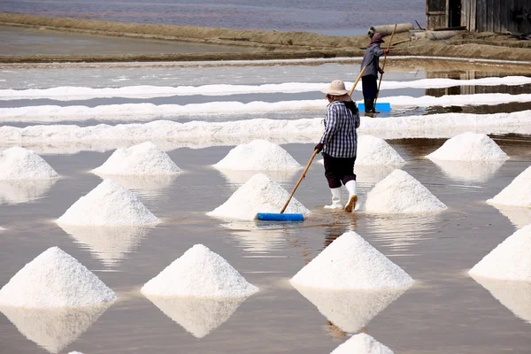 Workers in salt pans, Thailand.