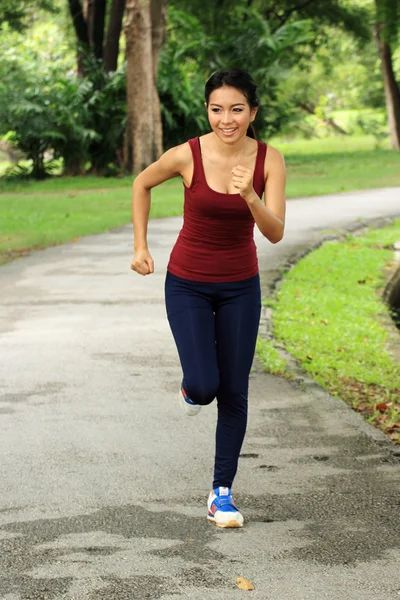 Asian woman running in park