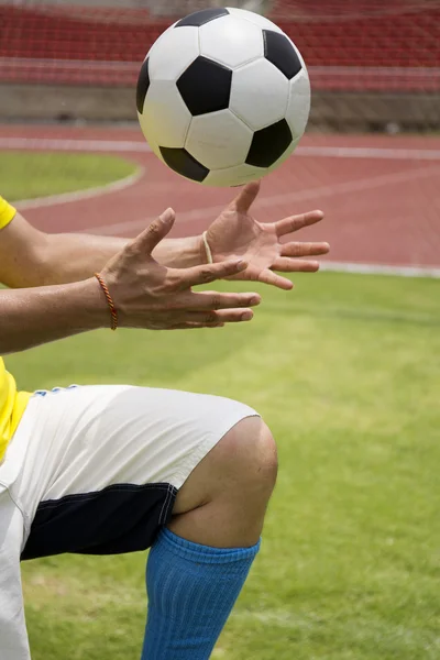 Soccer'hands reaching the foot ball