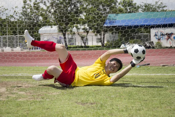 Goalkeeper catches the soccer ball