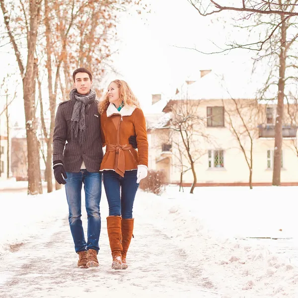 Young couple have a walk in the winter park