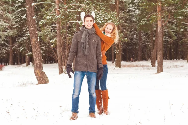 Young couple have a walk in the winter park