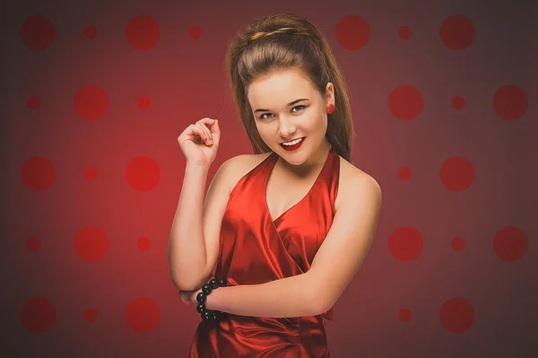 Stylized retro portrait of a young woman in red dress.