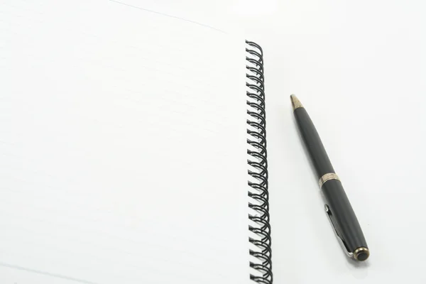 Notebook with pen on white background