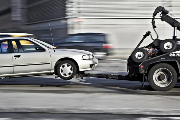 Tow truck delivers the damaged vehicle