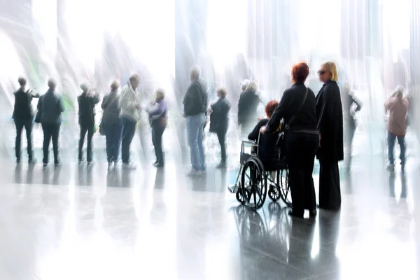 Group and disabled people in the lobby business center