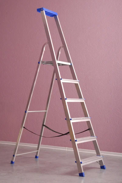 Metallic step-ladder is in home interior.
