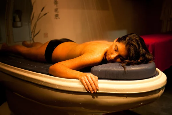 Lying relaxed woman during spa treatment.