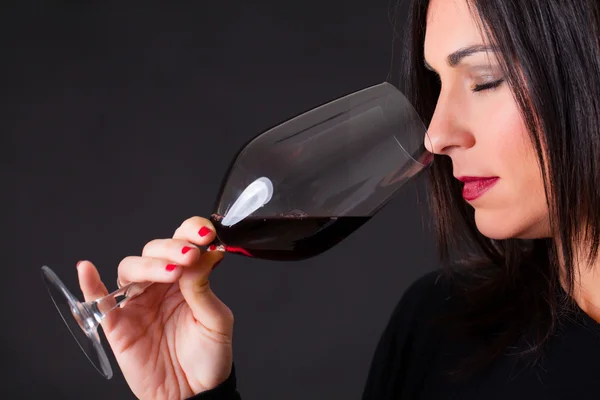 Wine expert smelling the aroma of a wine.