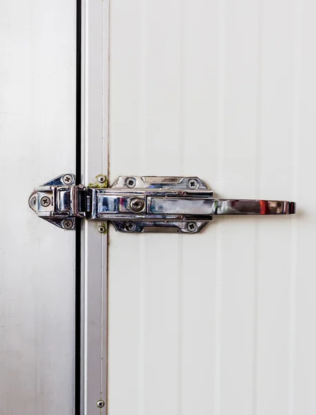 Aluminum door knob on the door of electric control in cooling ro